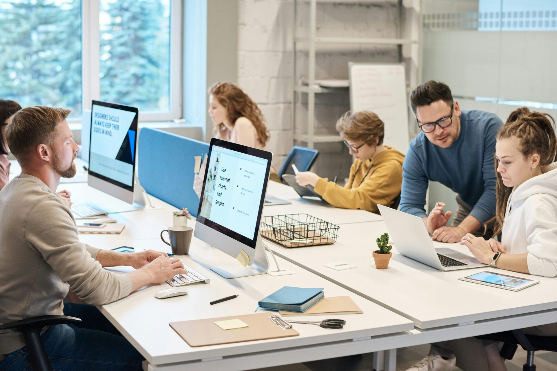 people working in an office with computers