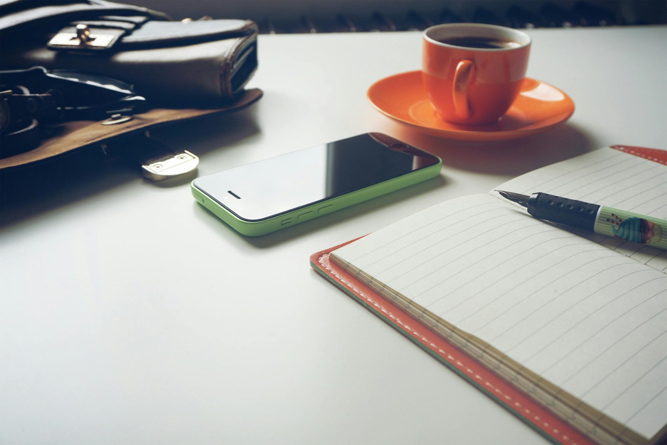 tax-saving tips for sole traders, orange coffee mug and notebook on a table