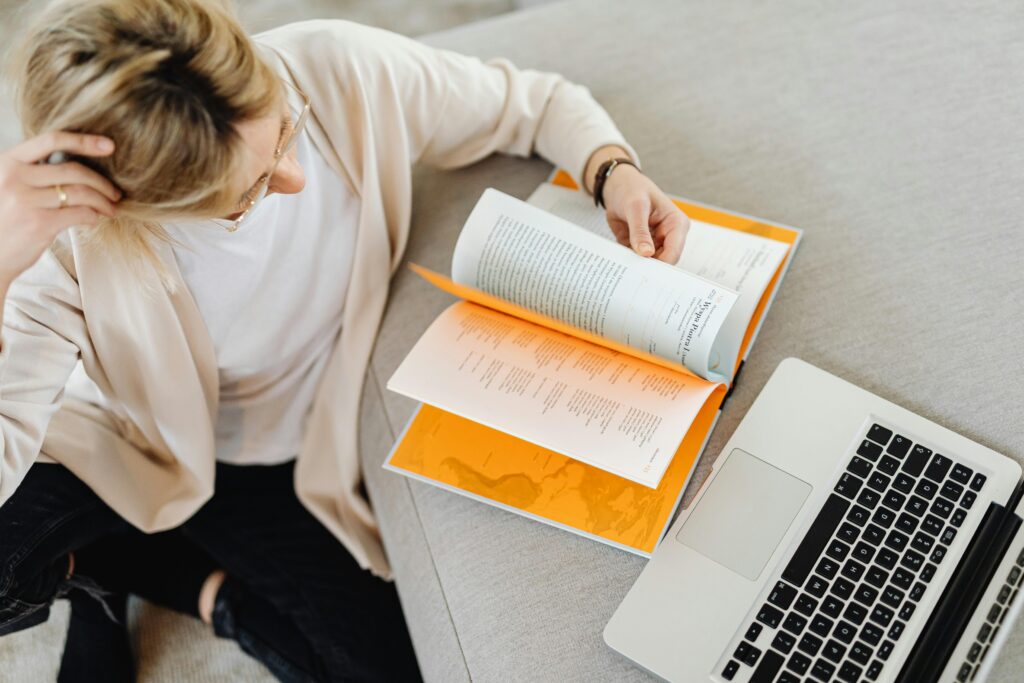 woman looking through a book for director hacks